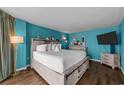 Comfortable bedroom featuring a king bed, accent wall, and stylish furnishings at 1501 Ocean Blvd. S # 1249, Myrtle Beach, SC 29577