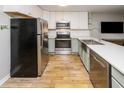 Modern kitchen with stainless steel appliances, light green cabinets, and subway tile backsplash at 1890 Colony Dr. # 18-C, Surfside Beach, SC 29575