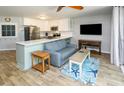 Cozy living room with stainless appliances, kitchen bar and blue couch with starfish rug at 1890 Colony Dr. # 18-C, Surfside Beach, SC 29575
