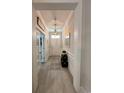 Bright entryway featuring light gray walls, white trim, a modern pendant light, and decorative accents at 200 Ponte Vedra Dr., Murrells Inlet, SC 29576