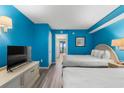 Comfortable bedroom with two beds, a TV, and access to a balcony at 2207 S Ocean Blvd. # 1517, Myrtle Beach, SC 29577