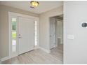 Inviting entryway featuring neutral walls, decorative light fixtures, and tile flooring at 231 Marbella Dr., Murrells Inlet, SC 29576