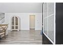 Bright foyer features lovely wood floors and decorative cabinet at 2475 Blue Crane Circle # 106, Myrtle Beach, SC 29577