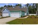 Stylish two-story home features a garage, manicured lawn, and welcoming pathway at 2475 Blue Crane Circle # 106, Myrtle Beach, SC 29577