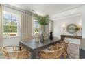 Bright dining area with a large window, wooden table, and decorative centerpieces at 251 Konik St., Conway, SC 29526