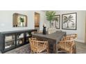 Elegant dining room with a wooden table, woven chairs, and stylish decor accents at 251 Konik St., Conway, SC 29526