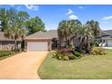 Beautiful brick home with mature landscaping, lush green lawn, and a spacious driveway at 2567 Lake Vista Dr., Little River, SC 29566