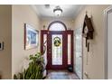 Inviting foyer with red door, transom window, and decorative wreath create a warm entry at 2567 Lake Vista Dr., Little River, SC 29566