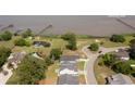 Aerial view shows community dock, lush greenery, neighborhood pool, and location of 2609 Seaport Cir at 2609 Seaport Circle, Georgetown, SC 29440