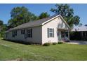 A charming single-story home with siding and a well-kept lawn on a sunny day at 304 S Magnolia Ave., Andrews, SC 29510