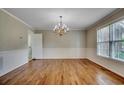 Formal dining area featuring hardwood floors, classic chandelier, and views to backyard at 3334 Cedar Creek Run, Little River, SC 29566