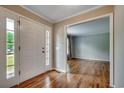 Bright foyer with hardwood floors, front door with sidelights, and view to formal living at 3334 Cedar Creek Run, Little River, SC 29566