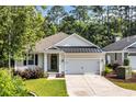 Inviting home exterior with a well-kept lawn, a two-car garage, and lovely curb appeal at 340 Scottsdale Ct., Murrells Inlet, SC 29576