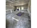 Spacious living room undergoing construction with new drywall and large windows at 3444 Asbury Rd., Aynor, SC 29511