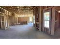 Unfinished home interior with wood framing and large windows, offering a spacious layout and natural light at 3530 Good Luck Rd., Aynor, SC 29511