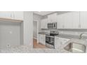 Modern kitchen featuring stainless steel appliances, granite countertops, and white cabinetry at 3539 Harrelson Ave., Loris, SC 29569