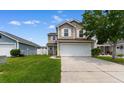 Charming two-story home featuring a spacious front yard, two-car garage, and neutral siding, all under a sunny sky at 4013 Blackwolf Dr., Myrtle Beach, SC 29579