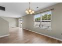 A bright living room features wood flooring, large windows, sliding doors, and fresh paint ready for personalization at 4013 Blackwolf Dr., Myrtle Beach, SC 29579