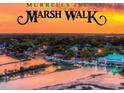 Aerial view of Murrells Inlet Marsh Walk over water at sunset at 4319 Lotus Ct. # A, Murrells Inlet, SC 29576
