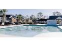 Relaxing pool area with palm trees in a community at 4319 Lotus Ct. # A, Murrells Inlet, SC 29576