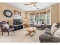 Cozy living room with plush sofas, a TV, and a bay window providing ample natural light, perfect for relaxation at 4574 Girvan Dr. # D, Myrtle Beach, SC 29579