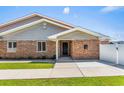 Charming brick home featuring a covered entrance and well-manicured lawn at 502 Garden Dr., Surfside Beach, SC 29575
