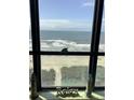 Breathtaking ocean view from a window, complete with beach decor at 523 S Ocean Blvd. # 705, North Myrtle Beach, SC 29582