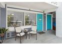 Inviting porch with chairs, a table, and a vibrant blue door at 5409 North Ocean Blvd. # 106/7108, North Myrtle Beach, SC 29582