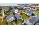 Aerial view of beach neighborhood with beach access, pool, parking and well-manicured lawns at 6 Indigo Ct., Ocean Isle Beach, NC 28469