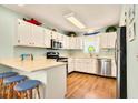 Bright kitchen featuring white cabinets, stainless steel appliances, and breakfast bar seating at 6 Indigo Ct., Ocean Isle Beach, NC 28469