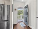 Inviting entryway with a modern gray door and tiled rug, opening to a light-filled outdoor space at 6253 Catalina Dr. # 733, North Myrtle Beach, SC 29582