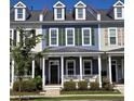 Row of colorful townhomes featuring dormer windows, shutters, and covered front porches at 750 Shine Ave. # 750, Myrtle Beach, SC 29577