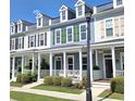 Charming street view of colorful townhomes with white porches, dormer windows, and manicured lawns at 750 Shine Ave. # 750, Myrtle Beach, SC 29577