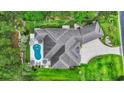 Aerial view of the property showing the pool, lush landscaping, and expansive roofline at 81 Cascade Dr., Murrells Inlet, SC 29576