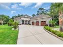 Charming single story home with a three car garage and spacious driveway surrounded by lush landscaping at 81 Cascade Dr., Murrells Inlet, SC 29576