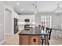 An open-concept kitchen offers stainless steel appliances, a center island, and a cozy breakfast nook at 8469 Cape Dutch Loop, Myrtle Beach, SC 29572