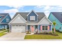 Charming home with a two-car garage, cheerful peach shutters, and an inviting front porch at 1008 Mary Read Dr., North Myrtle Beach, SC 29582