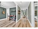 Open-concept living area boasts hardwood floors and neutral paint, flowing into other rooms of the home at 103 Pigeon Forge Ct., Murrells Inlet, SC 29576