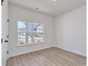 Bright bedroom with wood-look floors and a large window providing lots of natural light and outdoor views at 1079 Laconic Dr., Myrtle Beach, SC 29588