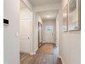 Inviting foyer with hardwood floors, a large mirror, and natural light streaming through the front door at 128 Dagger Ct., Myrtle Beach, SC 29588