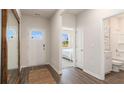 Bright hallway with access to a bathroom and bedroom featuring wood-look floors and neutral paint at 128 Dagger Ct., Myrtle Beach, SC 29588