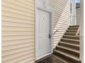 Exterior staircase leading to a private entrance, showcasing the building's access design and siding at 1298 River Oaks Dr. # 5-I, Myrtle Beach, SC 29579