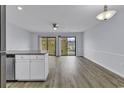 Bright living space with hardwood floors, ceiling fan, and a sliding door to the outdoor deck at 1600 Deer Creek Rd. # F, Myrtle Beach, SC 29575