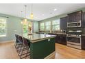 Modern kitchen with granite countertops, stainless steel appliances, and a spacious island with seating at 18 Cyclamen Ct., Murrells Inlet, SC 29576