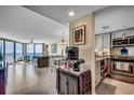 Open-concept living area with ocean view, tile flooring, and modern kitchen creating a luxurious ambiance at 1990 N Waccamaw Dr. # 1008, Murrells Inlet, SC 29576