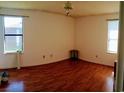 Spacious bedroom with hardwood floors, large windows, and neutral walls at 2005 Greens Blvd. # C-204, Myrtle Beach, SC 29577