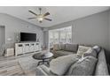Cozy living room features recessed lighting, ceiling fan, and a plush gray sofa at 2265 Huntingdon Dr. # J, Surfside Beach, SC 29575