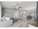 Inviting living room has gray walls, ceiling fan, hardwood floors and an eat-in kitchen at 2265 Huntingdon Dr. # J, Surfside Beach, SC 29575