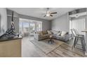 Comfortable living room has gray walls, ceiling fan, stylish furniture and a sunroom view at 2265 Huntingdon Dr. # J, Surfside Beach, SC 29575