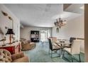 Cozy living room with comfortable seating, sliding glass doors, and a charming chandelier at 2309 Withers Dr. # 5, Myrtle Beach, SC 29577